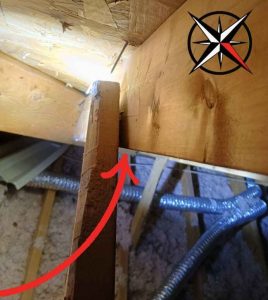 Attic Framing Separation Attic Scene with a Vertical Wooden Joist Showing a Crack Near a Joint Highlighted by a Red Arrow Ductwork and Insulation Visible Below